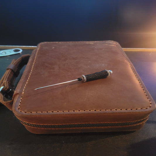 A brown leather luxury cigar humidor with a removable Cedar Cigar Holder and a cigar resting on top.
